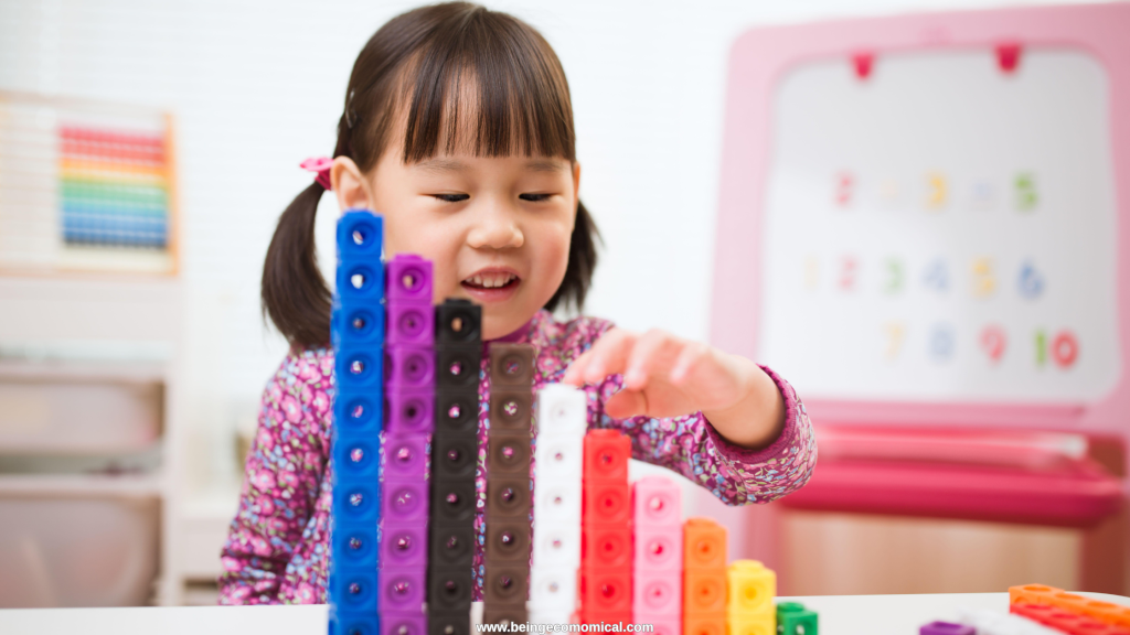 Preschool child counting and stacking colorful math cubes during an early learning activity.