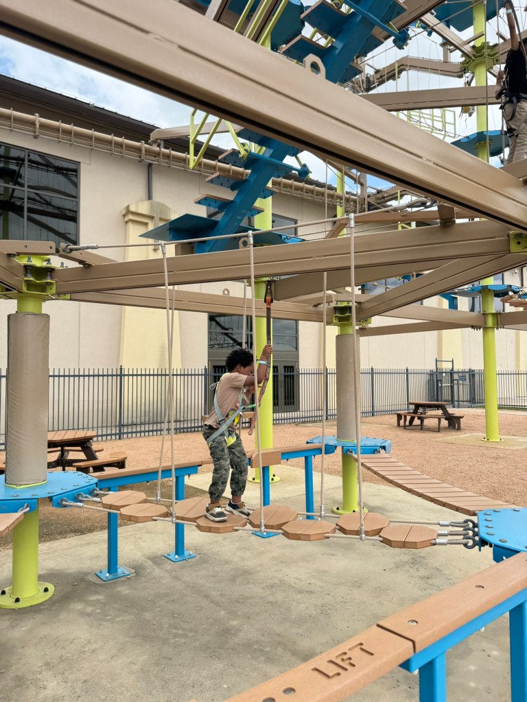 Preschooler enjoying outdoor ropes course at Great Wolf Lodge in Grapevine, Texas