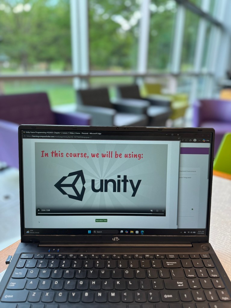 CompuScholar Unity Game Programming course introduction video on laptop screen