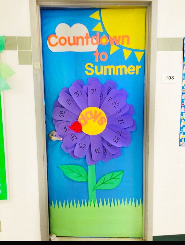 Countdown to summer classroom door with large flower petals labeled with days remaining and bright spring colors