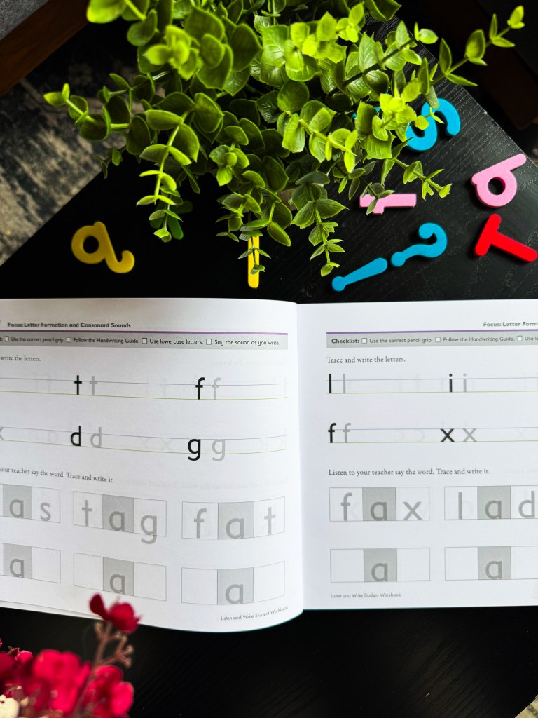 Spelling You See Level A student workbook showing letter tracing, handwriting lines, and beginner three-letter spelling activities.