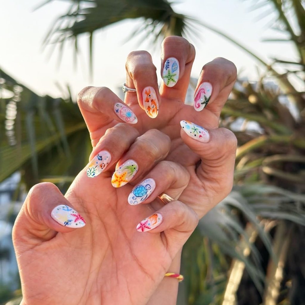 Colorful under the sea nails with tropical fish, sea turtles, coral art, and playful ocean-inspired nail details