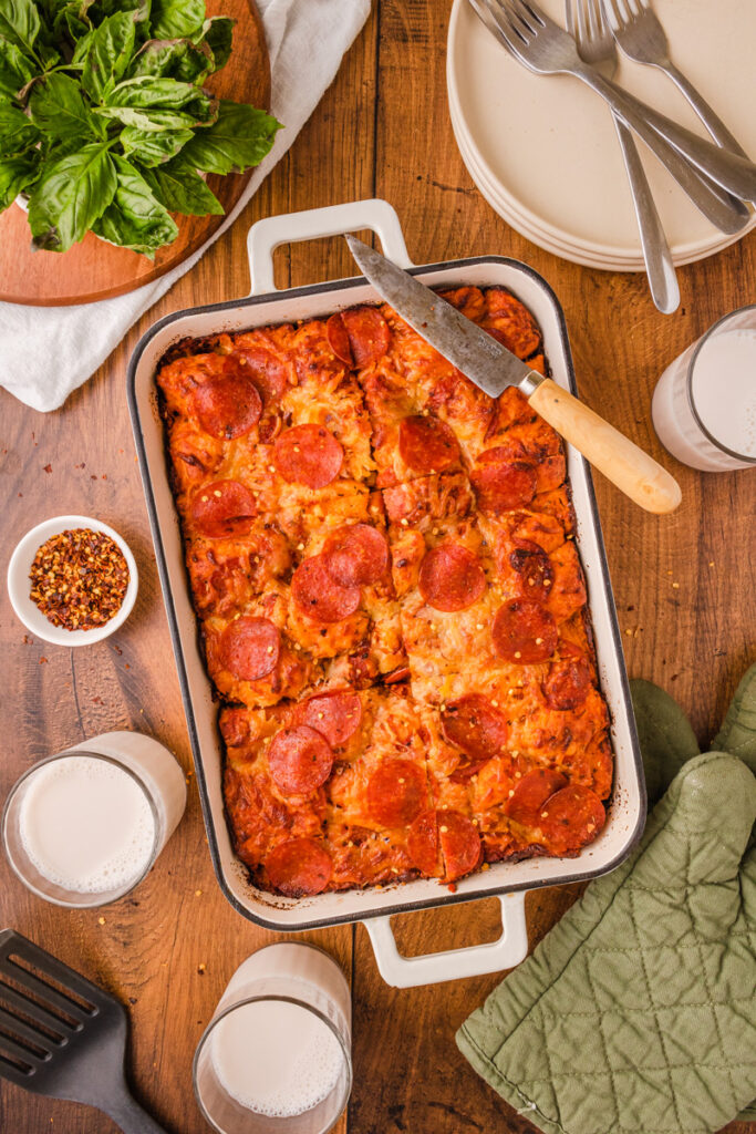 Bubble up pizza casserole with biscuit dough, marinara sauce, and melted cheese baked together