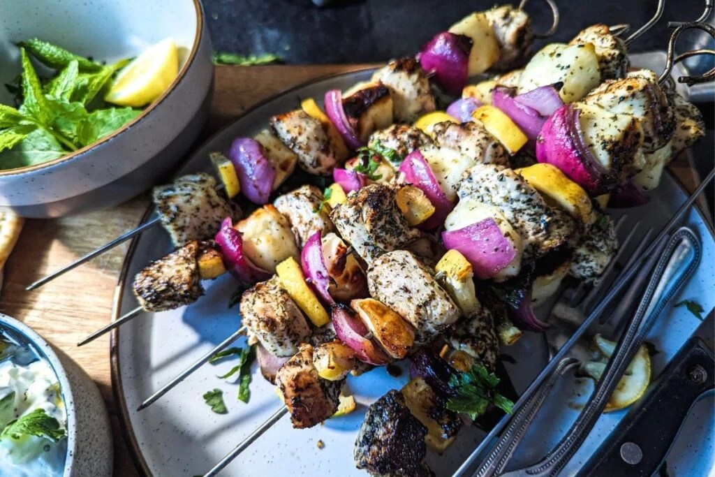 Chicken and halloumi skewers with red onion and lemon for an easy Greek-inspired summer dinner.