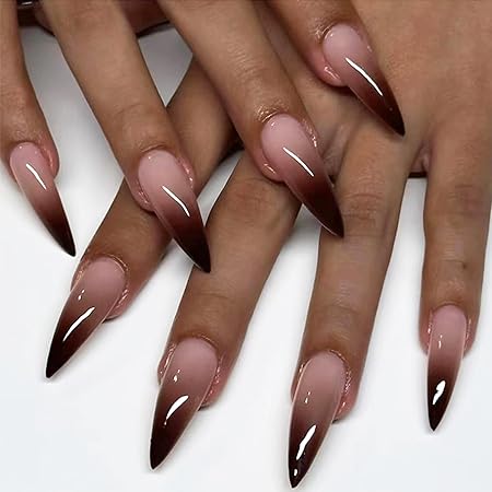 Close-up of hands with long almond-shaped nails showcasing a nude to deep brown ombre effect.