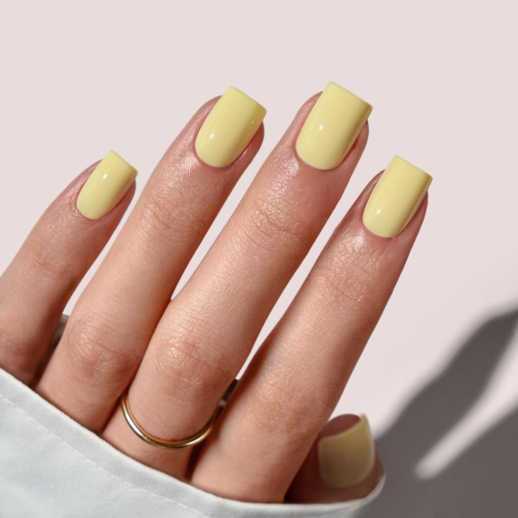 Butter yellow square acrylic nails with glossy pastel yellow polish and clean modern manicure design