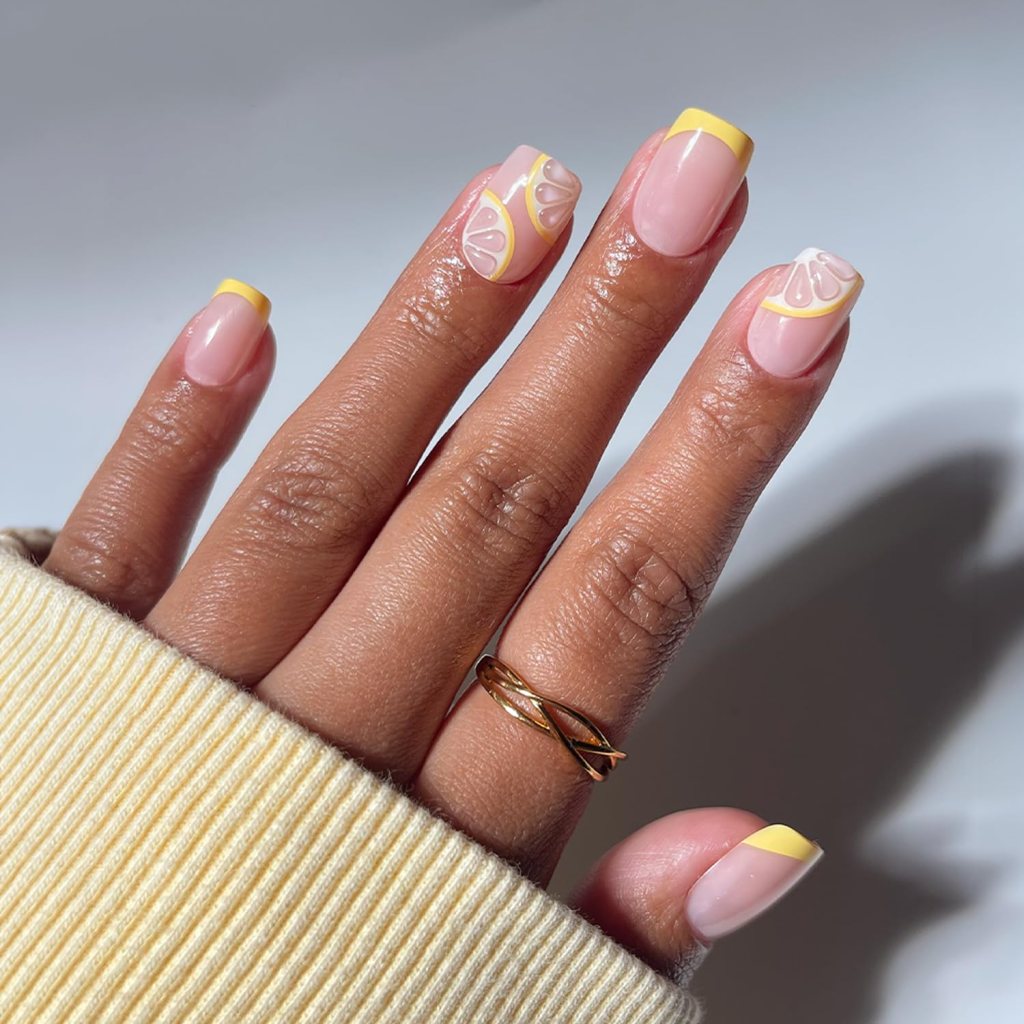 Butter yellow lemon French tip nails with citrus inspired nail art and glossy pastel manicure design