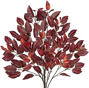 A bundle of vibrant red and orange autumn leaves arranged in a natural-looking display, perfect for fall decor.