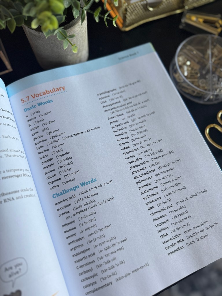 Close-up view of a page from Real Science 4 Kids Book 7, focusing on vocabulary words related to biology and RNA.
