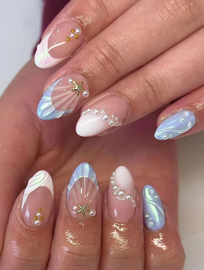 Iridescent seashell ocean nails with pearl accents and pastel blue mermaid-inspired nail art for summer