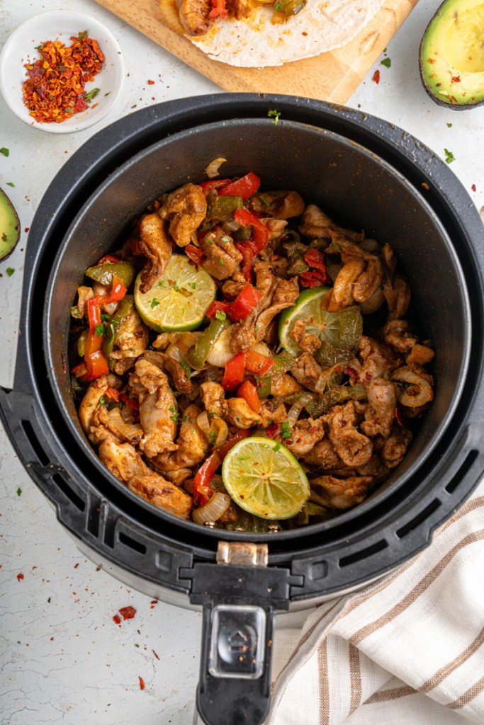 Air fryer chicken fajitas with peppers, onions, and seasoned chicken for a quick summer dinner.