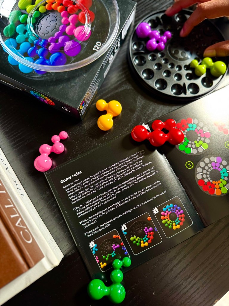 Partially completed IQ Circle expert puzzle using colorful game pieces