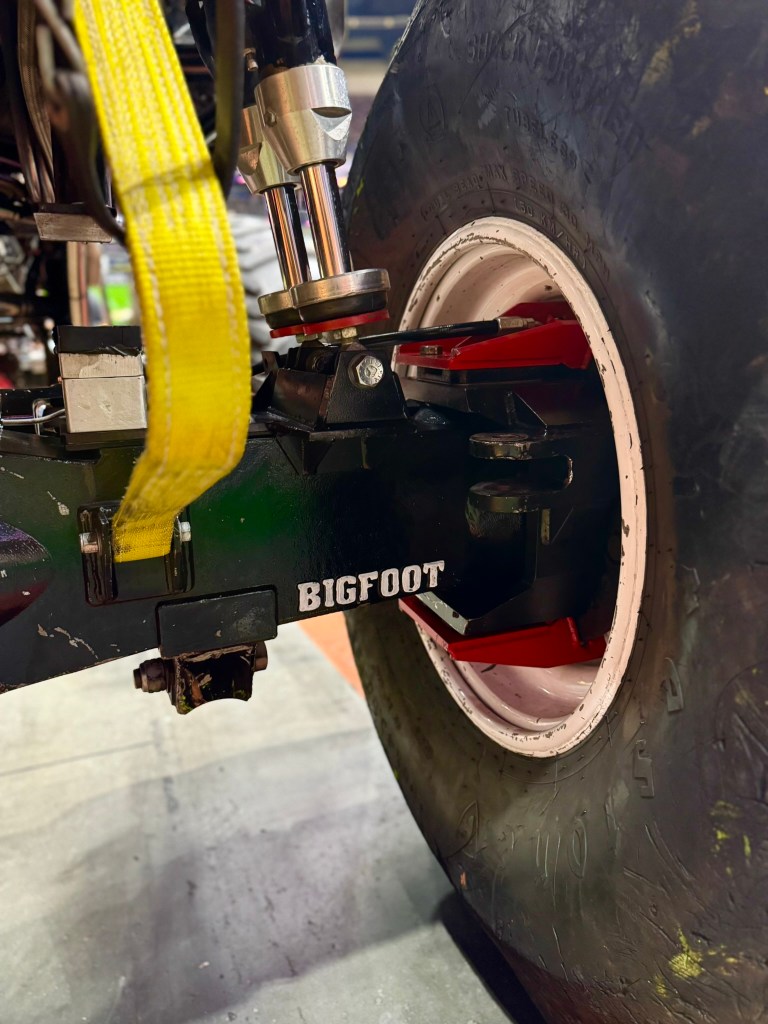 Close-up of Bigfoot’s suspension system, shock and wheel assembly.