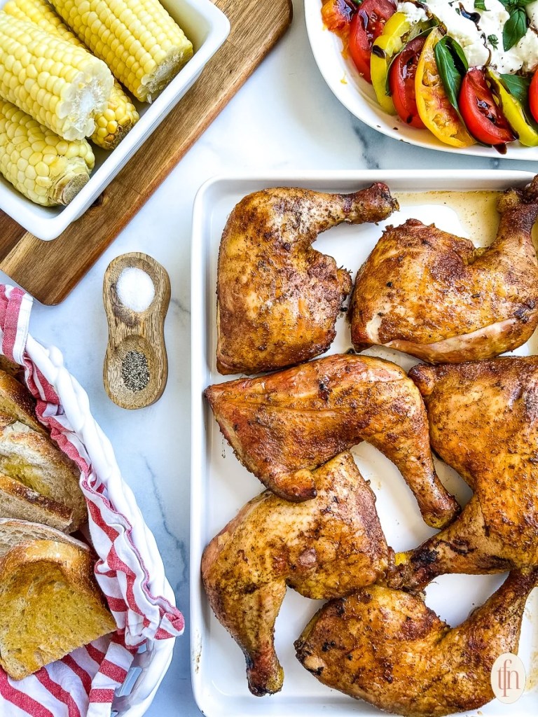Smoked chicken quarters with crispy skin and smoky barbecue flavor for a summer cookout dinner.