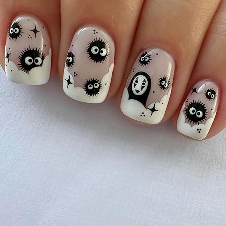 Nail design featuring playful black ghostly characters and eyeballs on a light pink base, complemented by white accents.