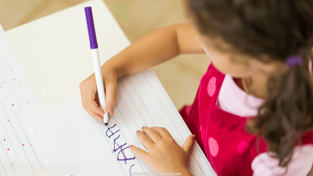 Young child practicing writing letters with a marker for an early preschool literacy activity