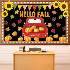 A classroom bulletin board featuring a red truck surrounded by pumpkins, fall leaves, and sunflowers with the text 'Hello Fall' in large letters.