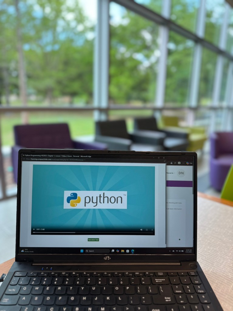 CompuScholar Python programming course video lesson displayed on laptop screen during homeschool coding lesson