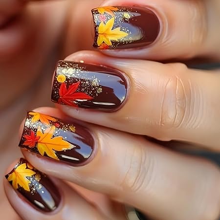 Close-up of beautifully manicured nails featuring a rich burgundy base with colorful autumn leaves and glitter accents, capturing the essence of fall.