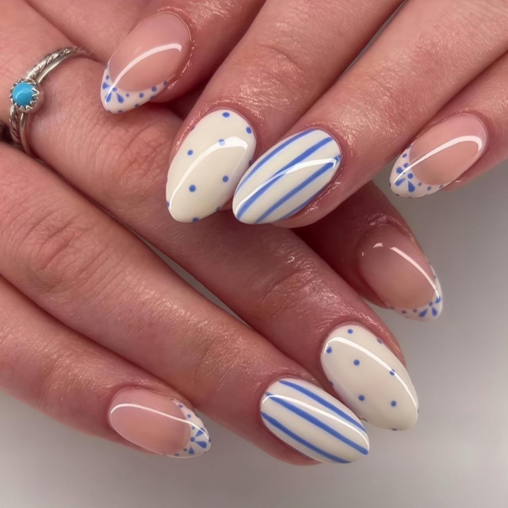 blue and white striped nautical nails with polka dot accents
