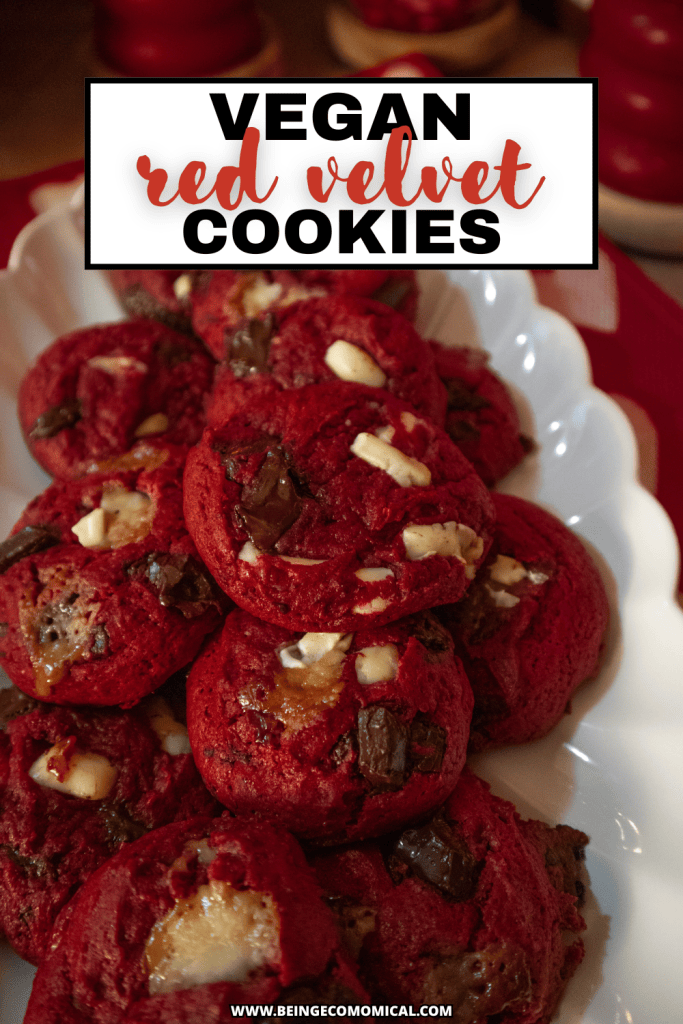 A plate of vegan red velvet cookies featuring a rich red color with chunks of chocolate and white chocolate chips.