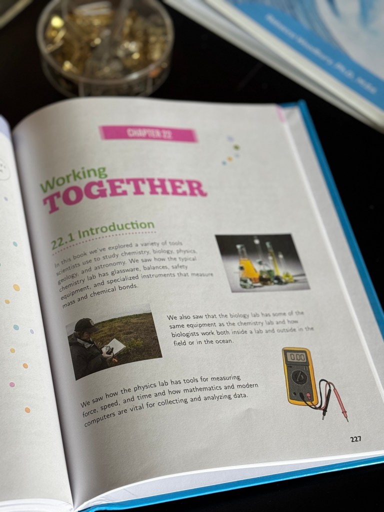 Close-up of an open textbook page titled 'Working Together' featuring colorful graphics and text discussing scientific tools and methods used in various fields like biology, chemistry, and physics.