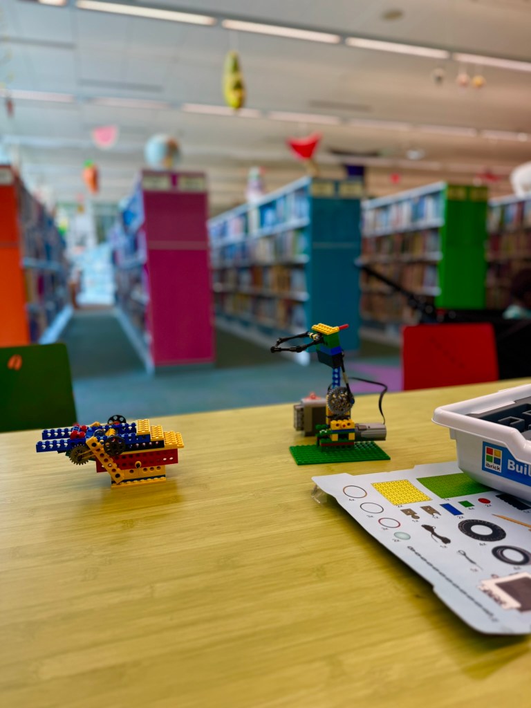 Close-up of an iBrick vehicle model being assembled by hand