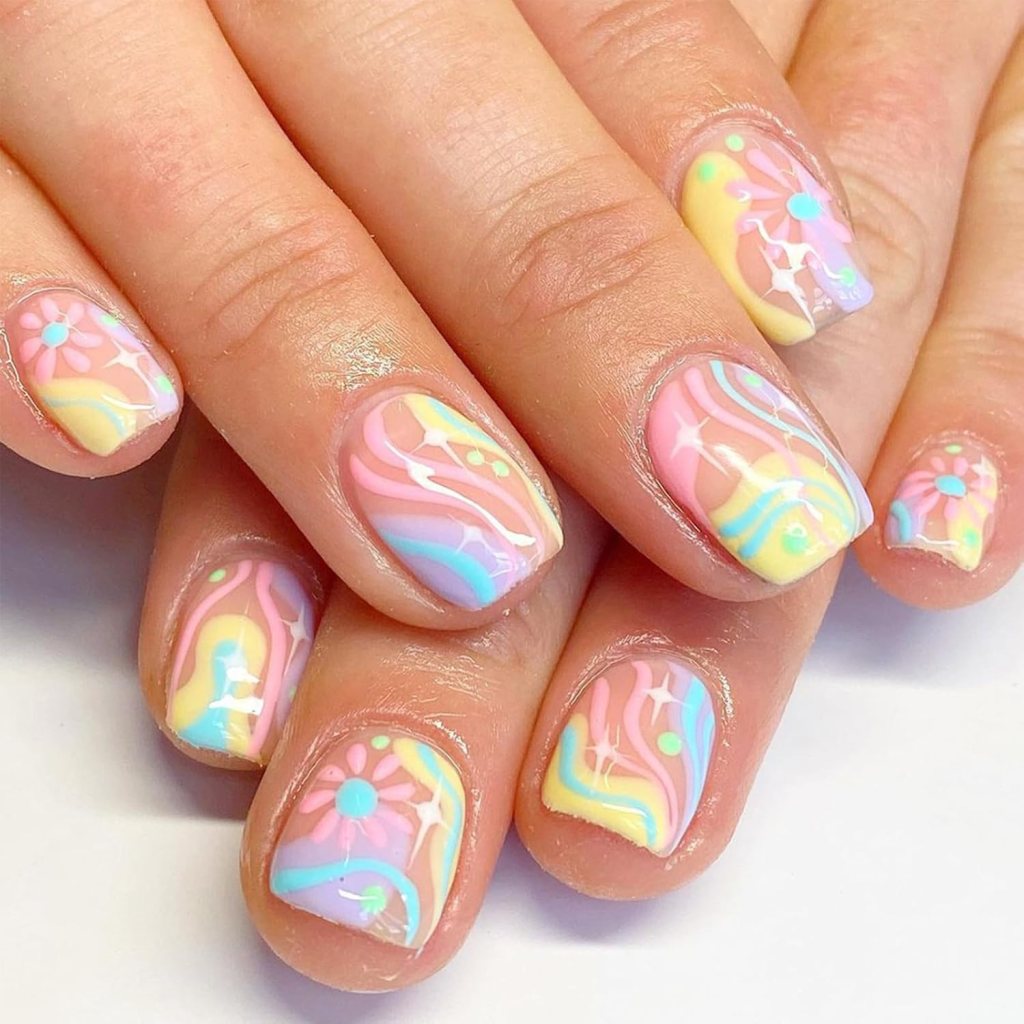 Close-up of manicured nails featuring a colorful nail art design with swirls of pastel pink, yellow, and blue, along with floral accents.