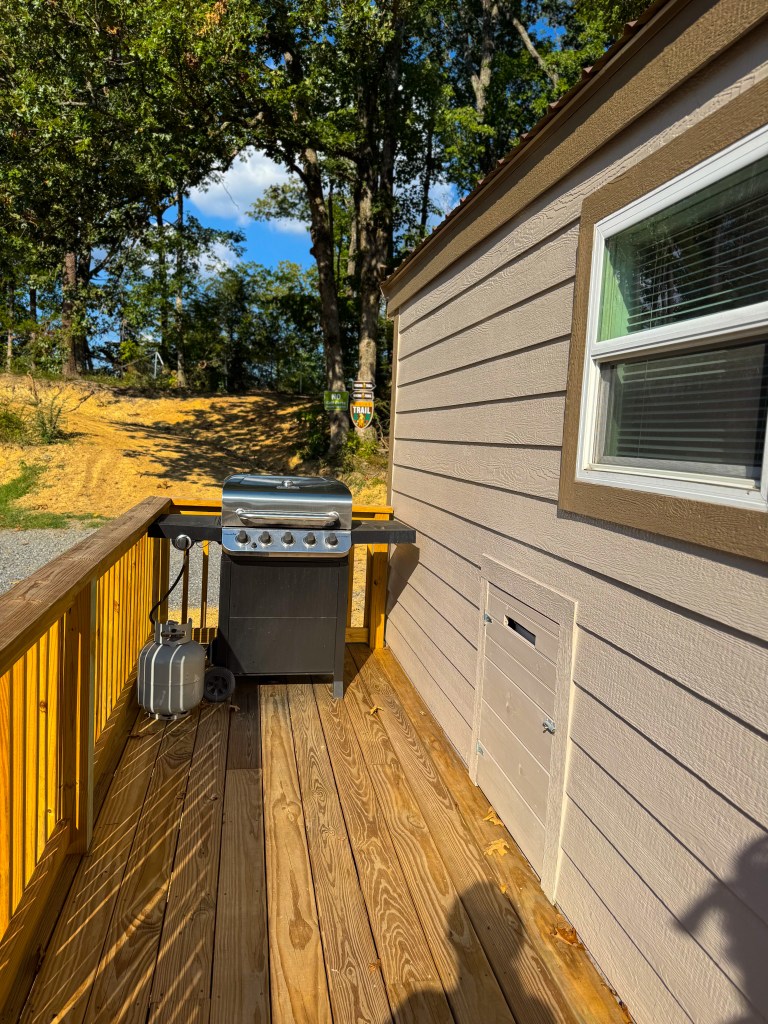 Private cabin deck with propane grill at Jellystone Park Pigeon Forge