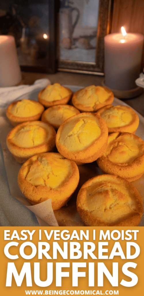 A plate of moist vegan cornbread muffins, golden and fluffy, with candles in the background, creating a warm and inviting atmosphere.