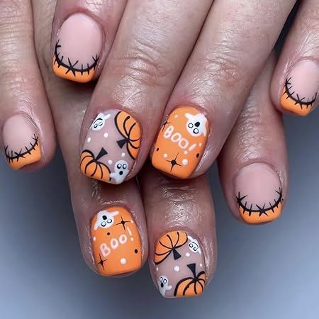 Orange Halloween nails featuring 'Boo!' lettering, pumpkins, and cute ghost faces with stitched black tips.
