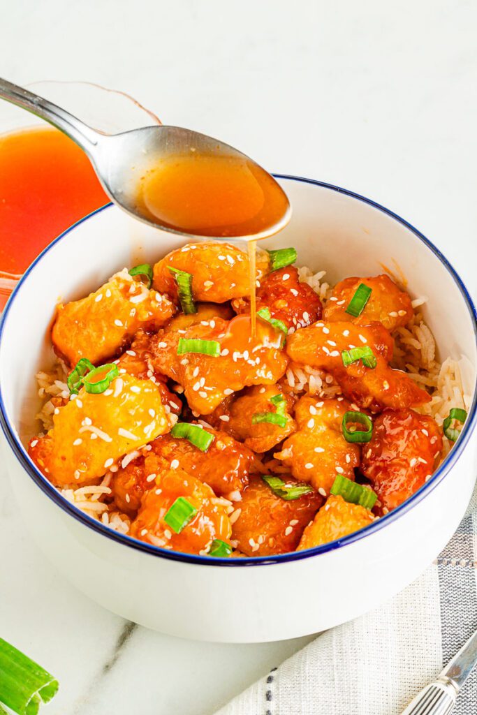 Gluten-free orange chicken with crispy chicken in a sweet citrus sauce