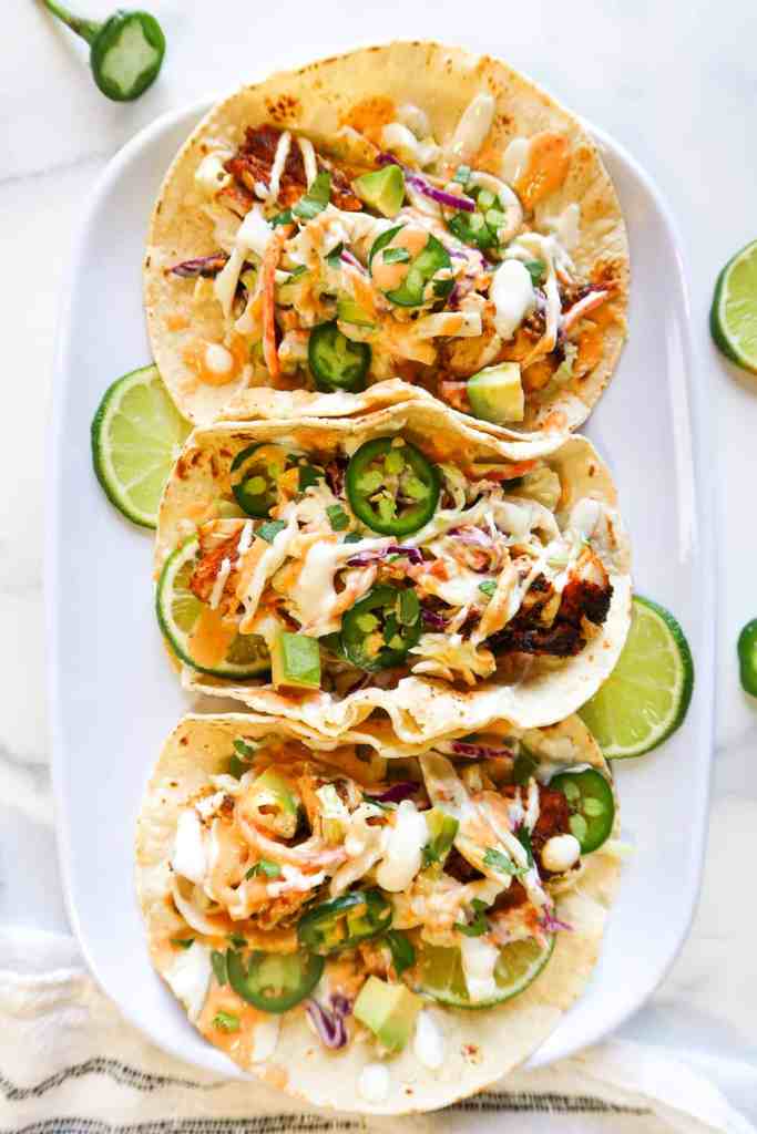 Blackened fish tacos with seasoned fish, slaw, and fresh toppings for a light summer dinner.