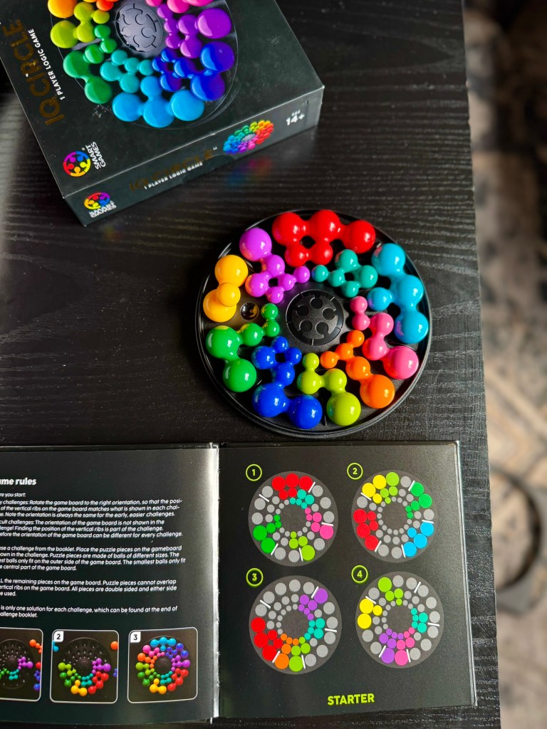 Completed IQ Circle starter-level puzzle with colorful pieces filling the board