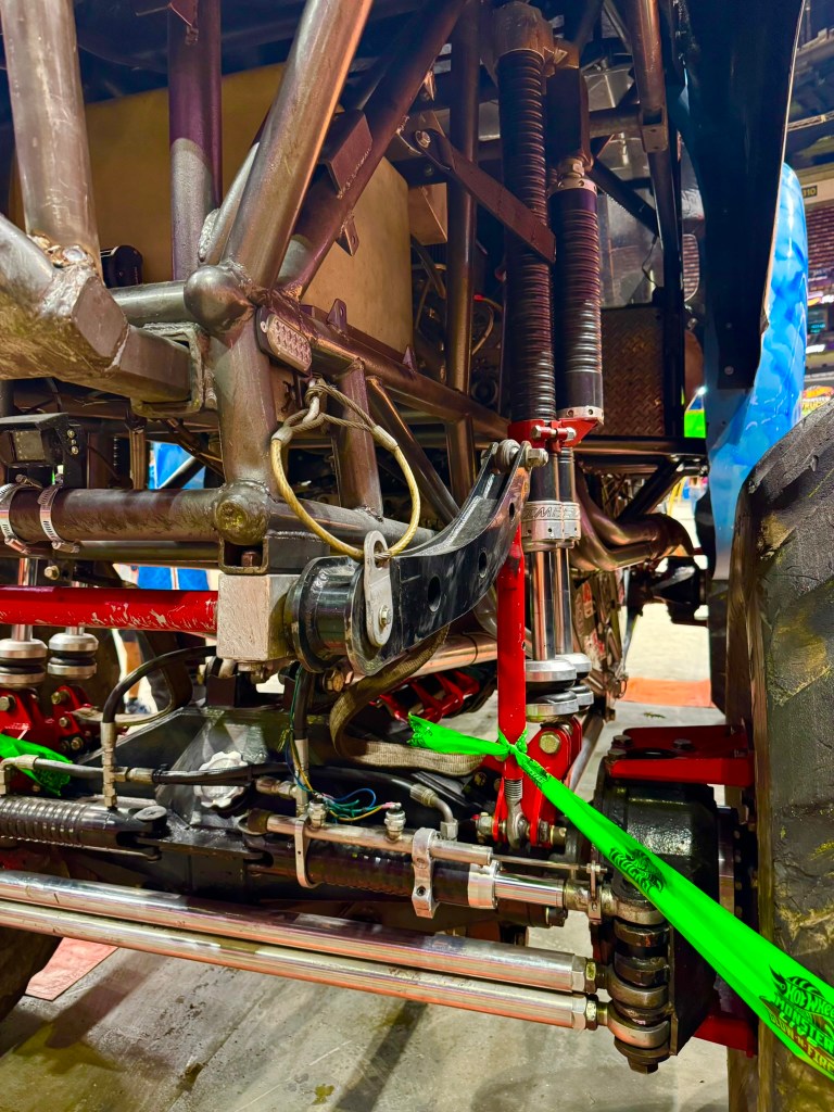 Detailed view of a Hot Wheels monster truck suspension, shocks and steering components.