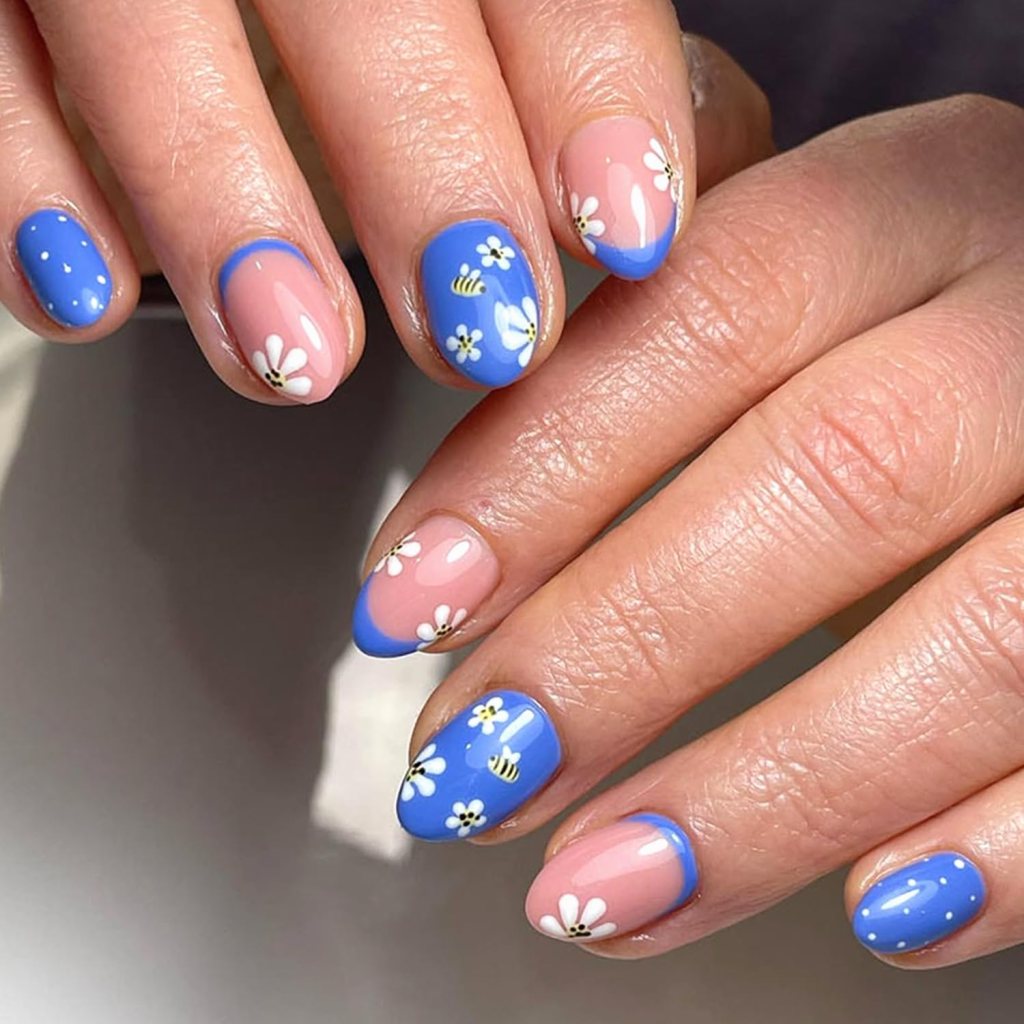 blue floral summer nails with bee accents on short round nails