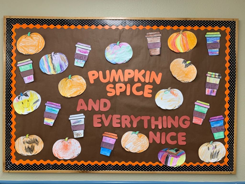 Fall classroom bulletin board featuring student-decorated pumpkins and coffee cups with a Pumpkin Spice and Everything Nice theme.