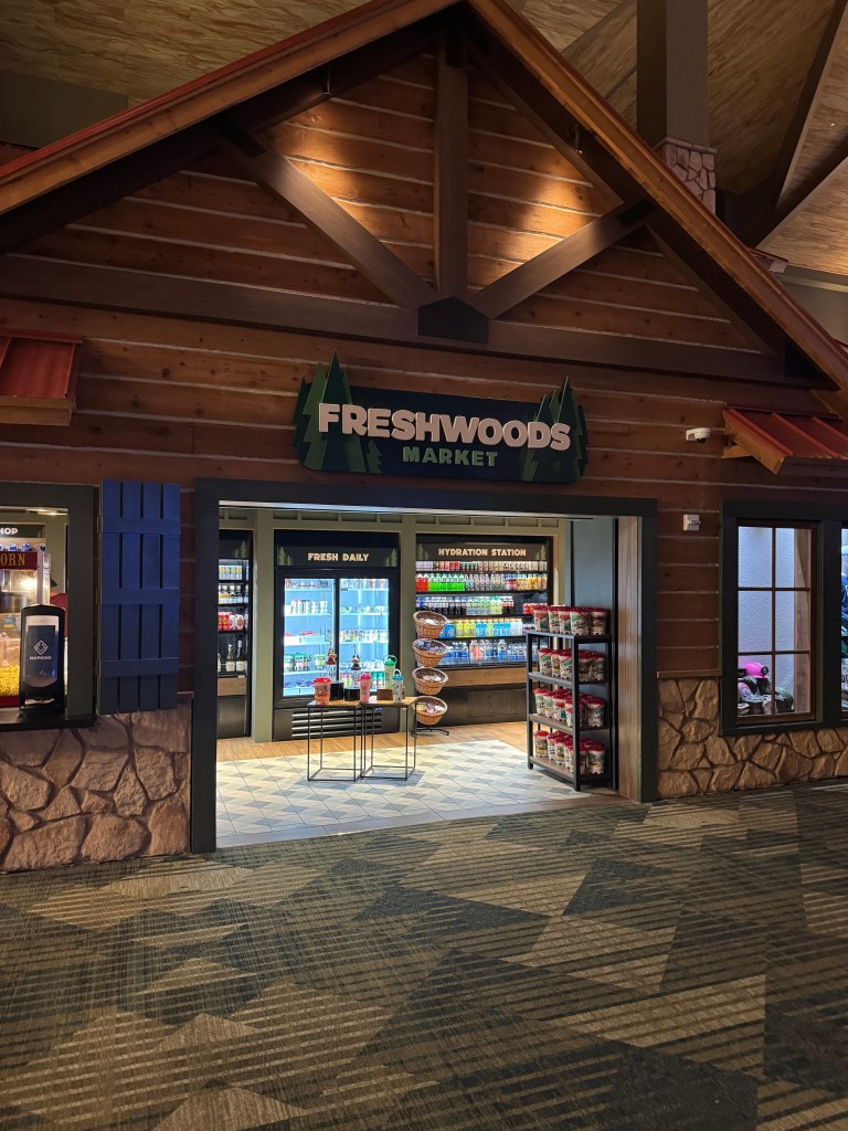Entrance of Freshwoods Market at Great Wolf Lodge in Grapevine, TX -  with rustic wooden design and product displays visible inside.