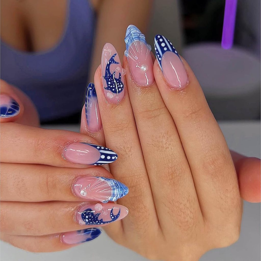 Navy blue ocean nails with seashell textures, underwater-inspired nail art, and glossy coastal manicure details