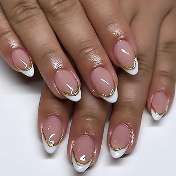 Close-up of manicured hands with nude-colored nails featuring white tips and gold accent lines.