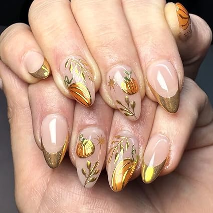 Manicure featuring elegant gold tips with hand-painted pumpkin and leaf designs, perfect for Thanksgiving.