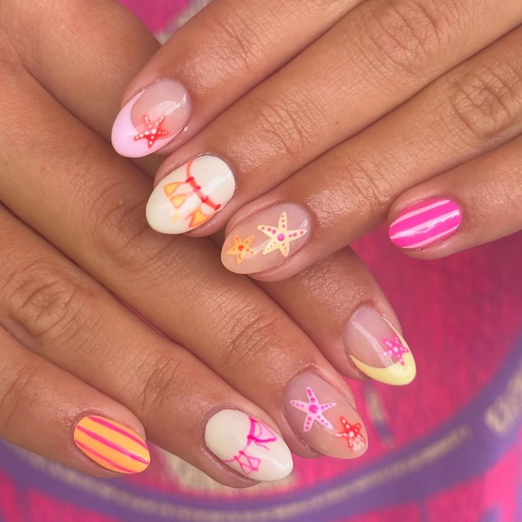 Pink summer ocean nails with starfish nail art, striped accents, and bright tropical beach-inspired colors