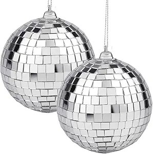 Two shiny, silver disco balls hanging with a sparkling mirror surface.
