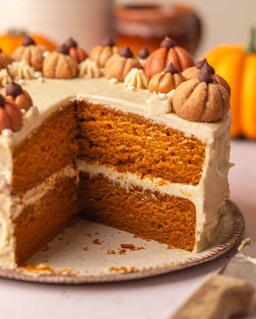 Pumpkin spice layer cake with cream cheese frosting – cozy fall dessert recipe.