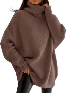 A woman wearing an oversized brown turtleneck sweater, styled with black leggings.