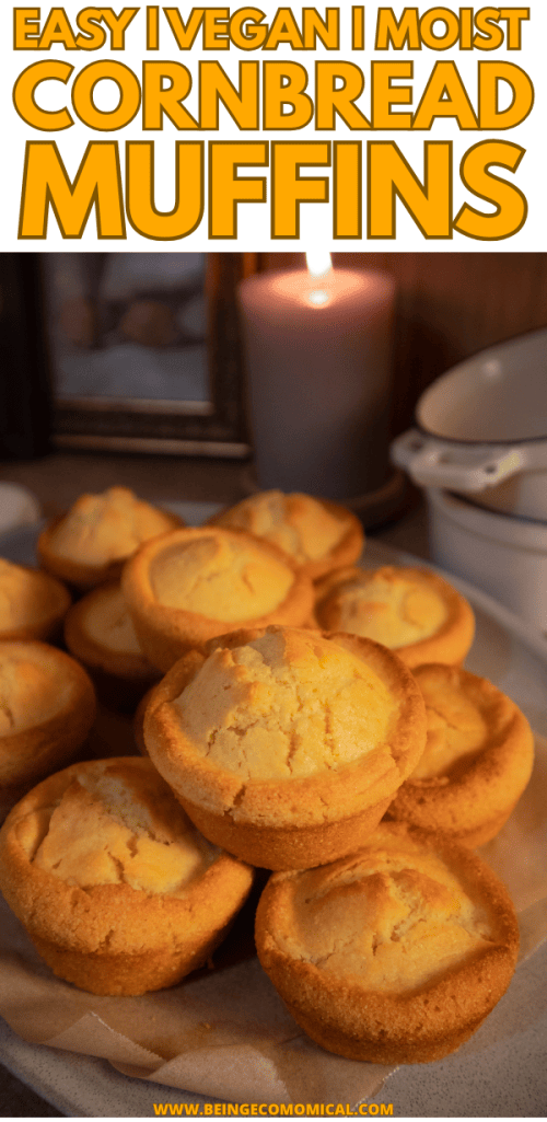 A plate of freshly baked vegan cornbread muffins, golden brown with a slightly domed top, displayed in a cozy setting with soft lighting.