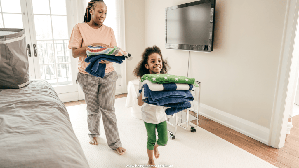 Mom and young child folding towels together as a practical learning activity for 4 year olds.