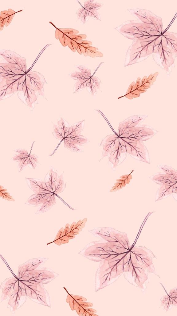 A soft pink background featuring scattered watercolor leaves in warm autumn tones, including shades of orange and brown, creating a cozy fall aesthetic.