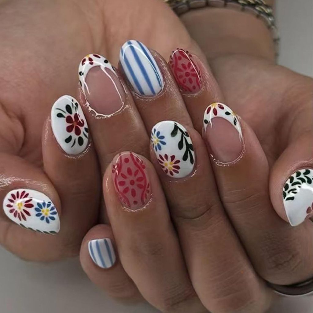 colorful mixed pattern summer nails with bright floral designs and striped accents on almond nails