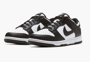 A pair of black and white Nike Dunk sneakers with a classic design, featuring a low-top silhouette and contrasting color blocking.